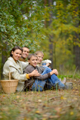 Portrait of family of four in park