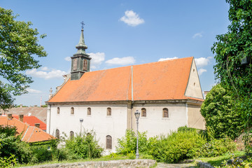 Petrovaradin, Serbia - July 17. 2019: Petrovaradin fortress; Roman Catholic church of st Juraj; View from the steps of the fortress