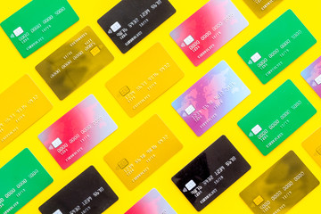 Credit cards for online payment on yellw background top view pattern