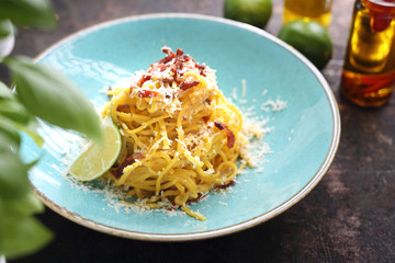 Spaghetti carbonara with creamy sauce, bacon and parmesan