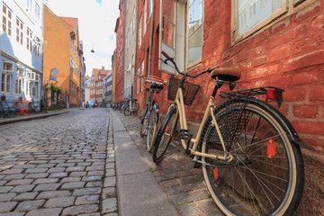 Two locked bicycycles in Copenhagen colorful old town street