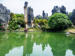 Ashima Rock at a small lake at Stone Forest in the county "Shilin" (Yunnan Province - China). A Girl named Ashima was forbidden to marry her Lover and turned into a rock.