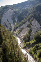 View of a wild rauen ravine with wild river in the Village Davos Wiesen, Swiss Alps