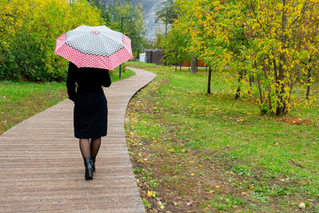 Young woman is quitting of bad relations. Autumn is comig. Concept of loneliness cause of breaking up or divorce