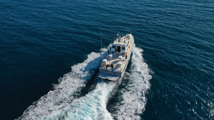 Aerial drone photo of small powerboat cruising in high speed in deep blue Mediterranean sea