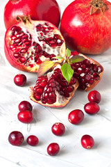 Group of fresh summer fruits -  pomegranates  with green leaves