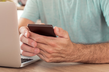 Freelancer using smart phone in home office