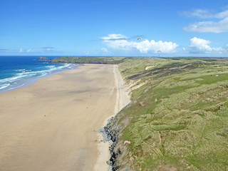 Paragliders above Perranporth Beach
