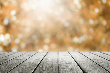 Naklejka na ściany i meble Wooden table and blurred bokeh autumn background.