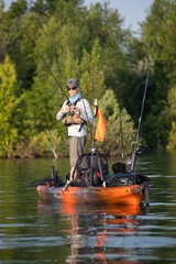 Young Man Kayak Fishing at Sunrise in Canada