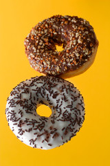 sweet flying doughnuts on a vibrant yellow background
