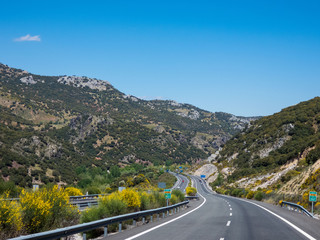 Road mountains clouds curve asphalt.