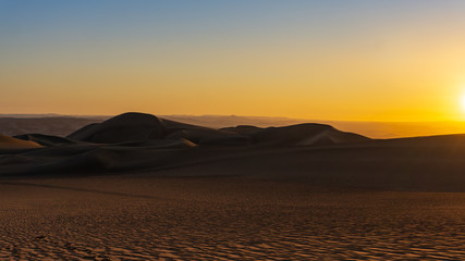 Fototapeta na wymiar Sunset in the desert of ica