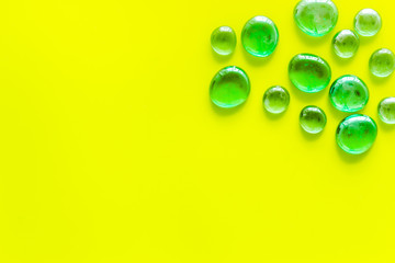 Bright stones on yellow background top view mock up