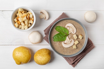 mushroom cream soup on white wooden board. Top view