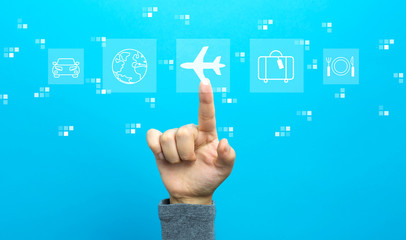Airplane travel theme with hand on a blue background