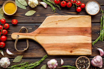 Cutting board in frame of food for chef work on wooden background top view space for text