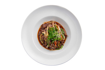 Wok with beef and green beans isolated on white