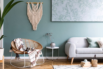 Modern boho interior design of sitting room with design rattan armchair, gray sofa, coffee table,...