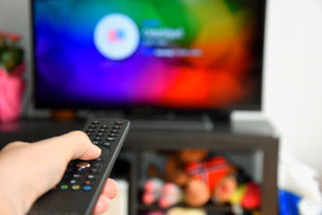 woman choosing tv program