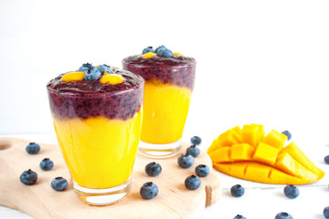 Layered smoothie with mango and blueberry fruit