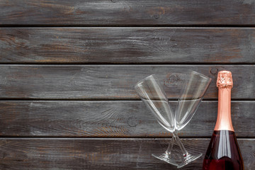 Party with champagne bottle and glasses on wooden background top view space for text
