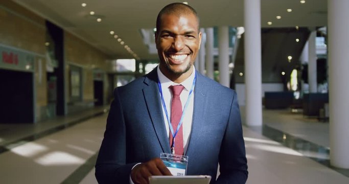 African American businessman looking at camera in a modern office 4k