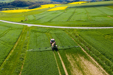 Aerial view, tractor sprays a field with fertilizer, Wetterau, Hesse, Germany