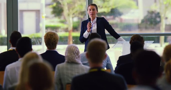 Female speaker speaks in a business seminar at modern office 4k
