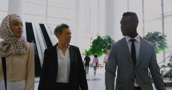 Mixed race and African American business people interacting with each other in the lobby at office 4k