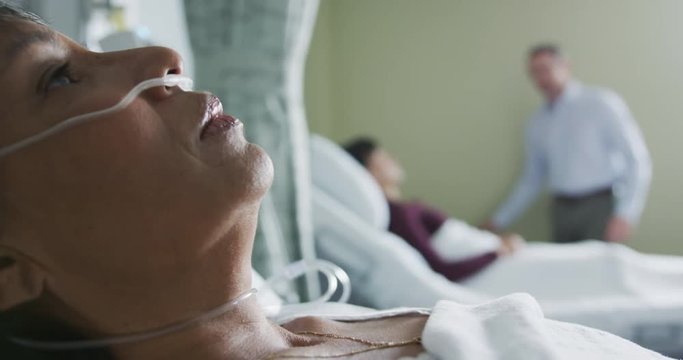 Middle aged woman lying on hospital bed 4k