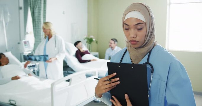 Young female intern making notes in a hospital ward 4k