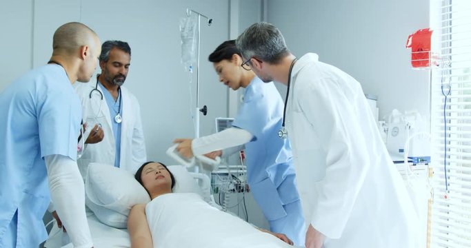 Doctors resucitating a patient in hospital bed 4k