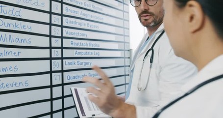 Doctors meeting around information board 4k
