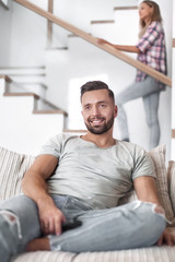 close up. young man sitting on sofa.