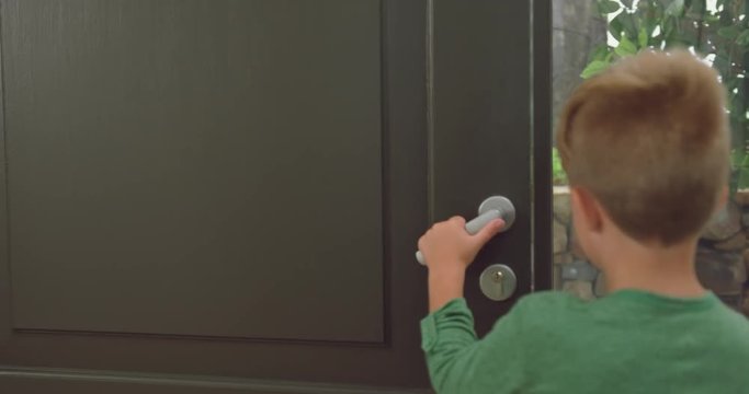 Boy opening the door and embracing his father in a comfortable home 4k