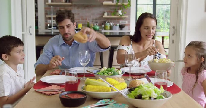 Family having meal together on dinning table at home 4k
