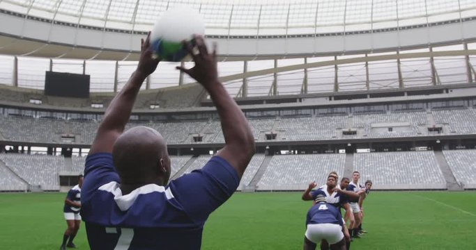Male rugby players playing rugby match in stadium 4k