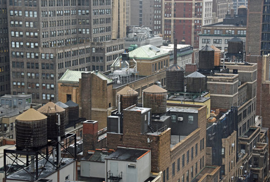 Looking down at roofs with water tanks in New York City