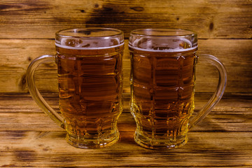 Two glasses of beer on wooden table