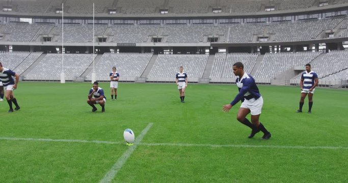 Male rugby player kicking rugby ball in ground at stadium 4k