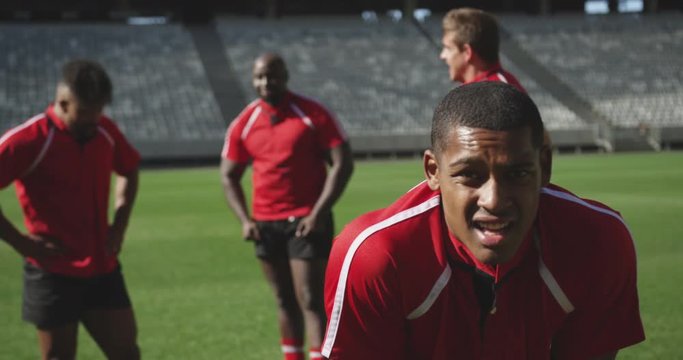 Male rugby player standing with hands on hip in stadium 4k