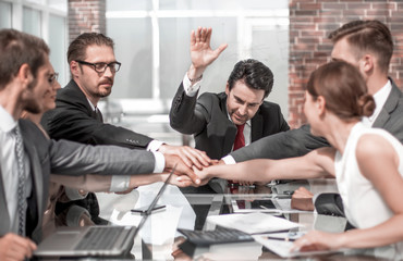 business colleagues working in the office, holding hands together