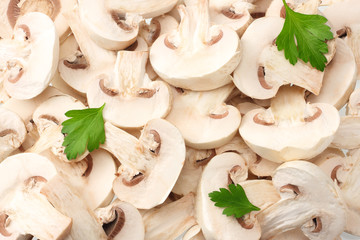 Sliced mushrooms with parsley leaves as background texture. healthy food
