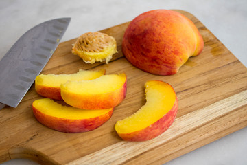 Slicing Peaches on a Wood Cutting Board