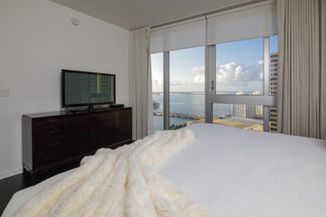 Fototapeta na wymiar Photo of a bedroom with view of the bay
