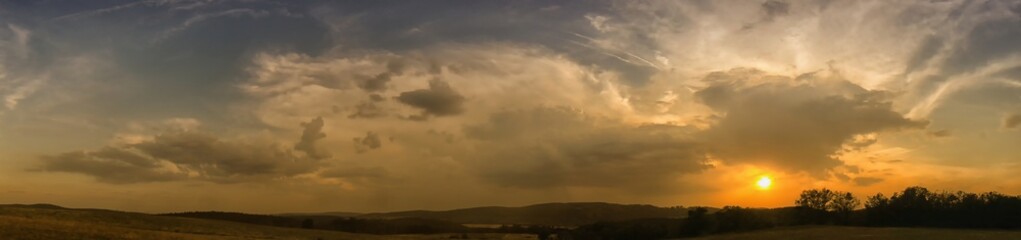 Decaying storm cloud during a sunset at summer evening