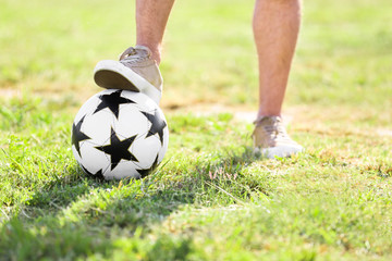 Man with with soccer ball outdoors