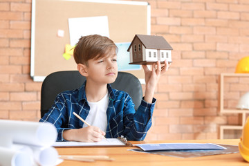 Cute little architect working in office