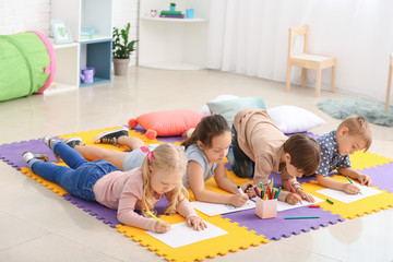 Cute little children drawing in kindergarten